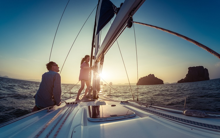 Weltumsegelumg - zwei Segler auf Yacht im Sonnenuntergang